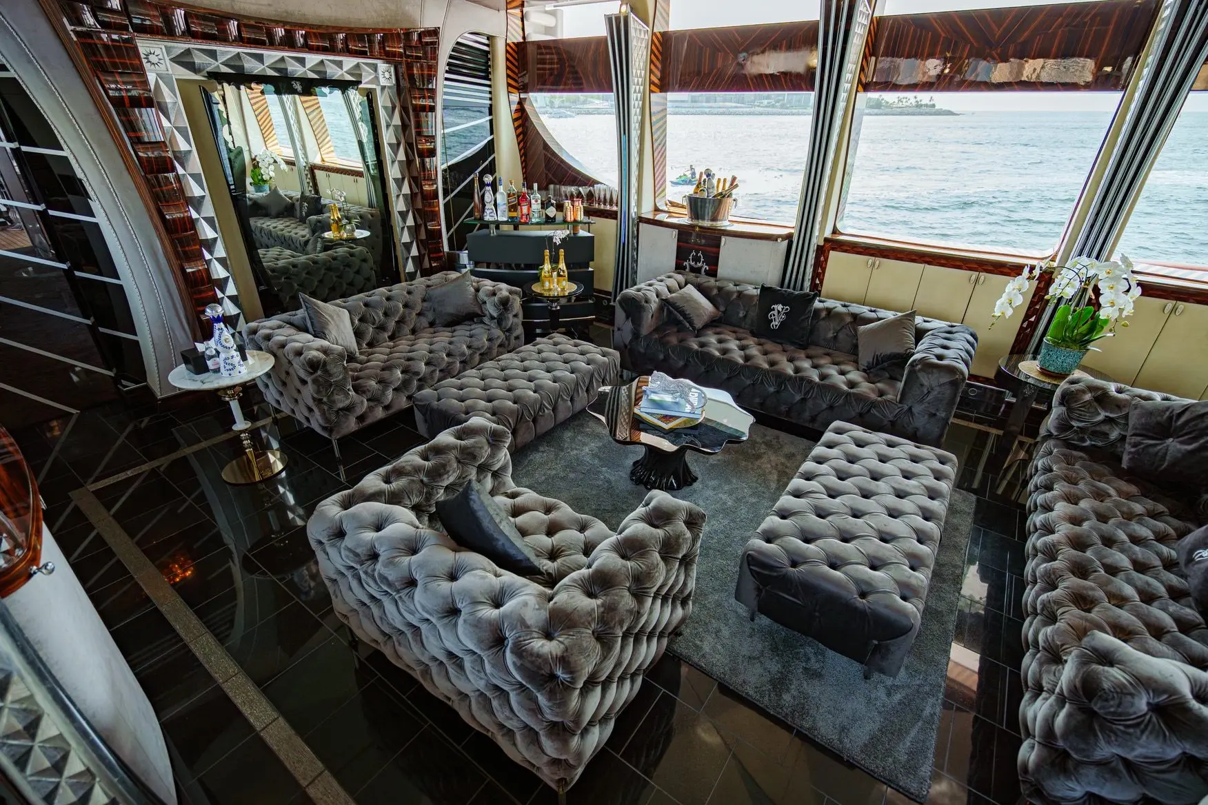 Thunder Superyacht main salon with tufted sofas and elegant interior design
