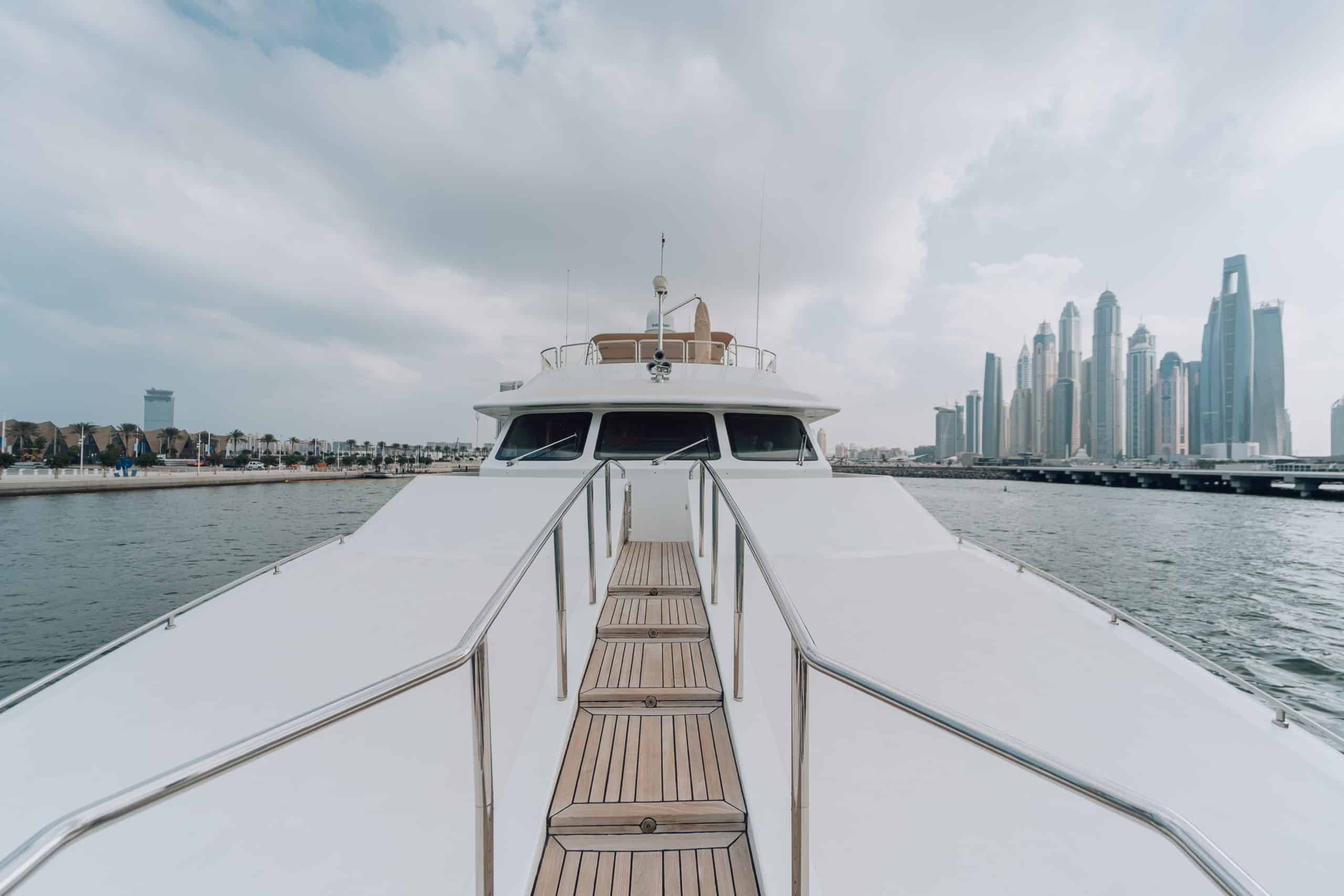 Luxury yacht deck with city skyline in the background.