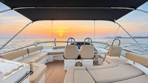 Empress 80 flybridge lounge at sunset on the open water