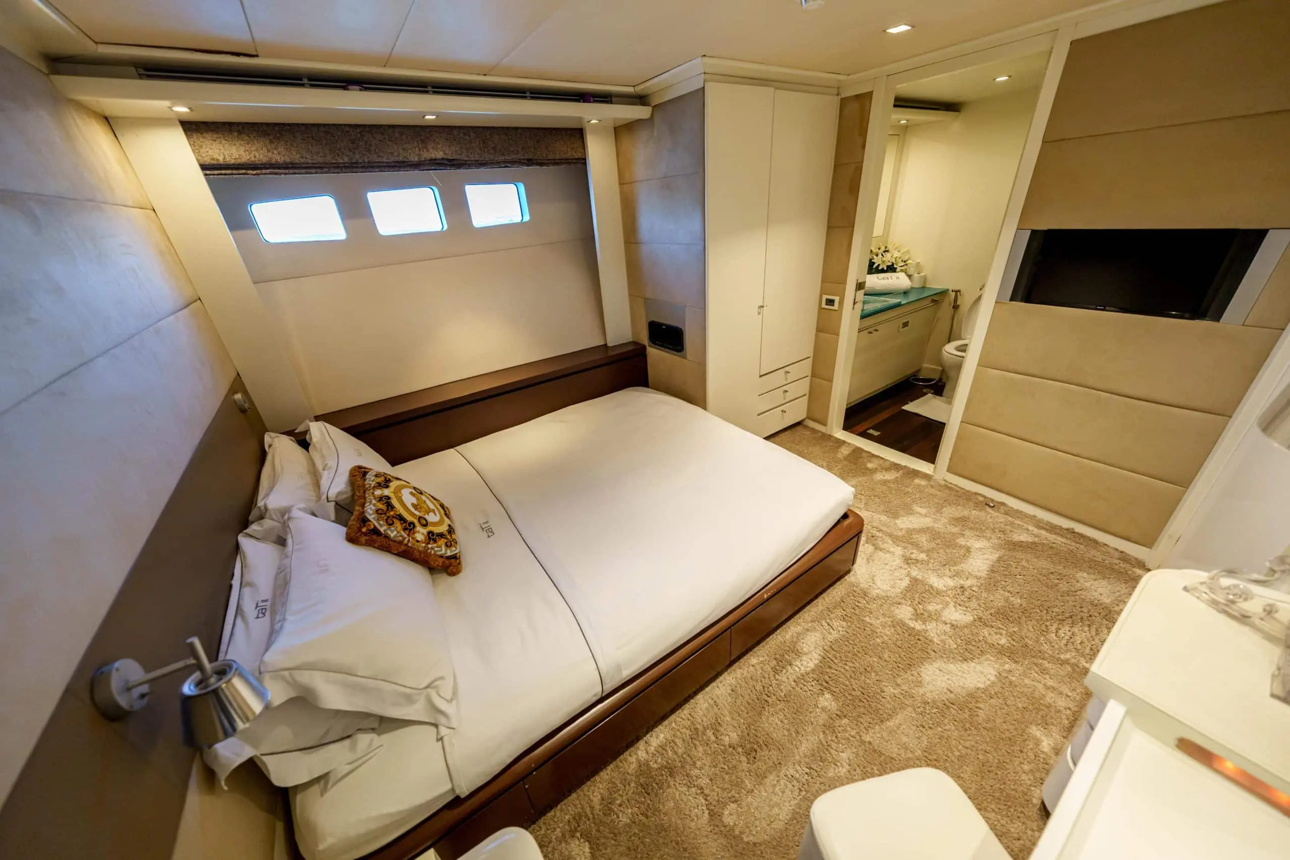 Master bedroom cabin with ensuite bathroom on Tatti 110 yacht