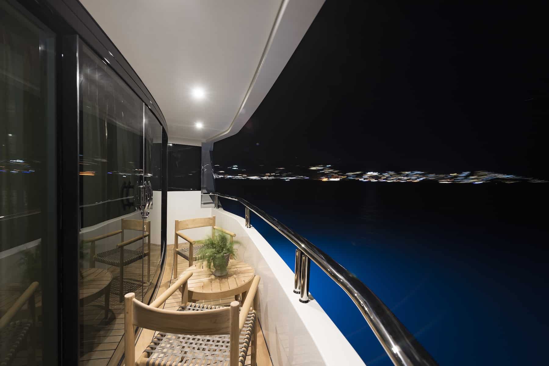 Skyfall 177 yacht side deck at night with illuminated walkway