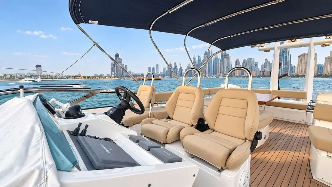 Empress 80 flybridge helm and seating with Dubai Marina skyline