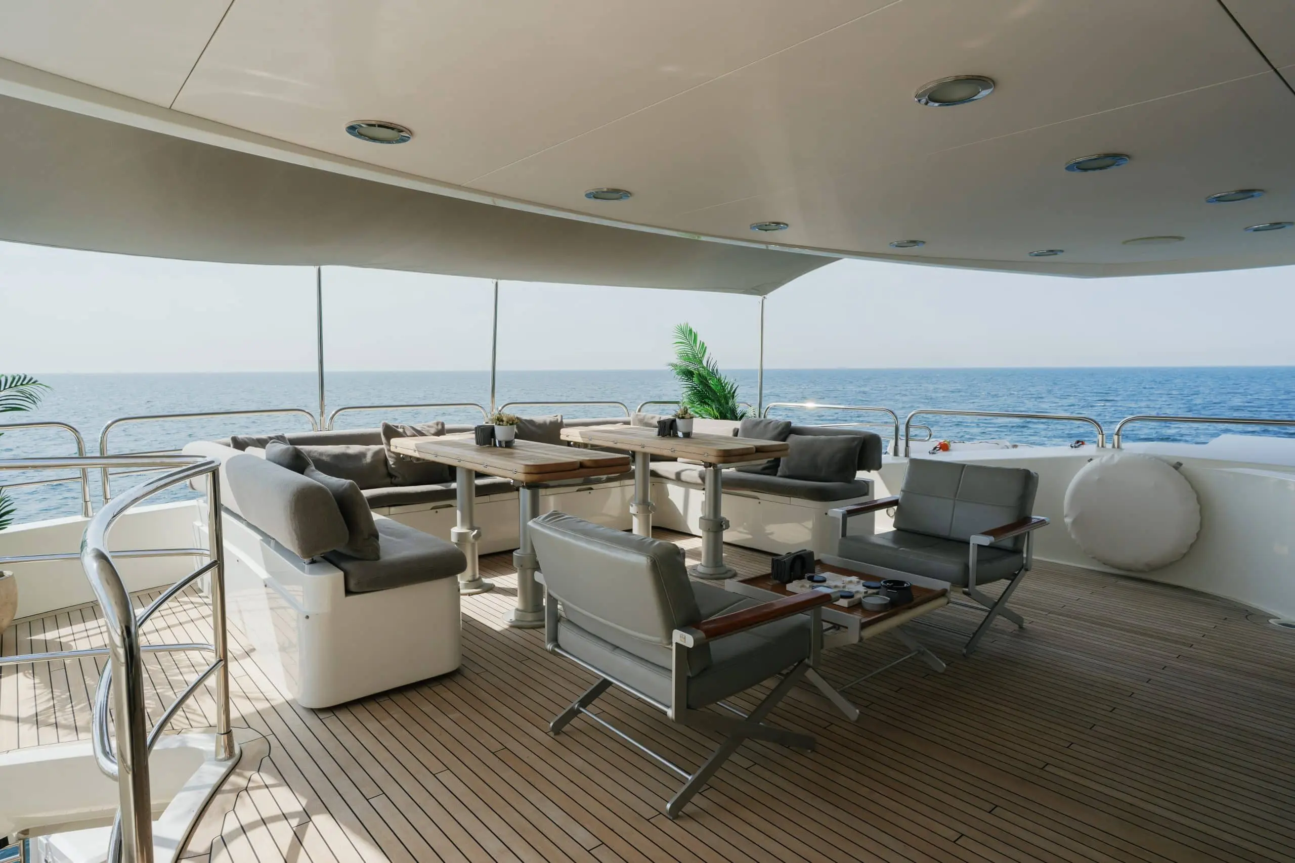 Aurora 130 yacht aft deck lounge with cushioned seating and ocean backdrop