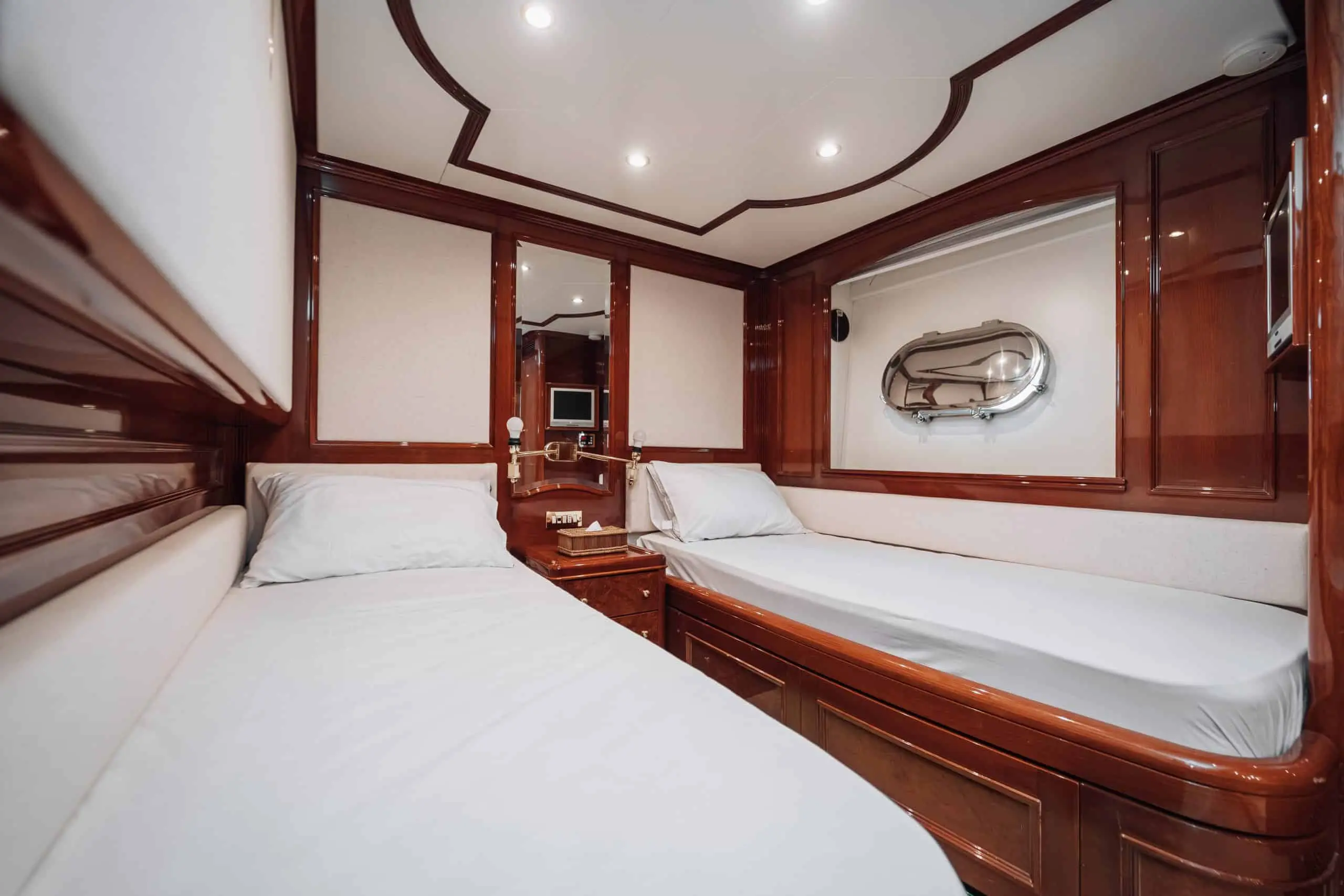 Interior lounge area inside Royal Mirage yacht cabin with wooden décor