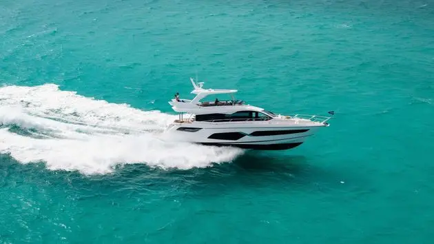 Sunseeker Manhattan 68 cruising clear turquoise water — shipyard photo