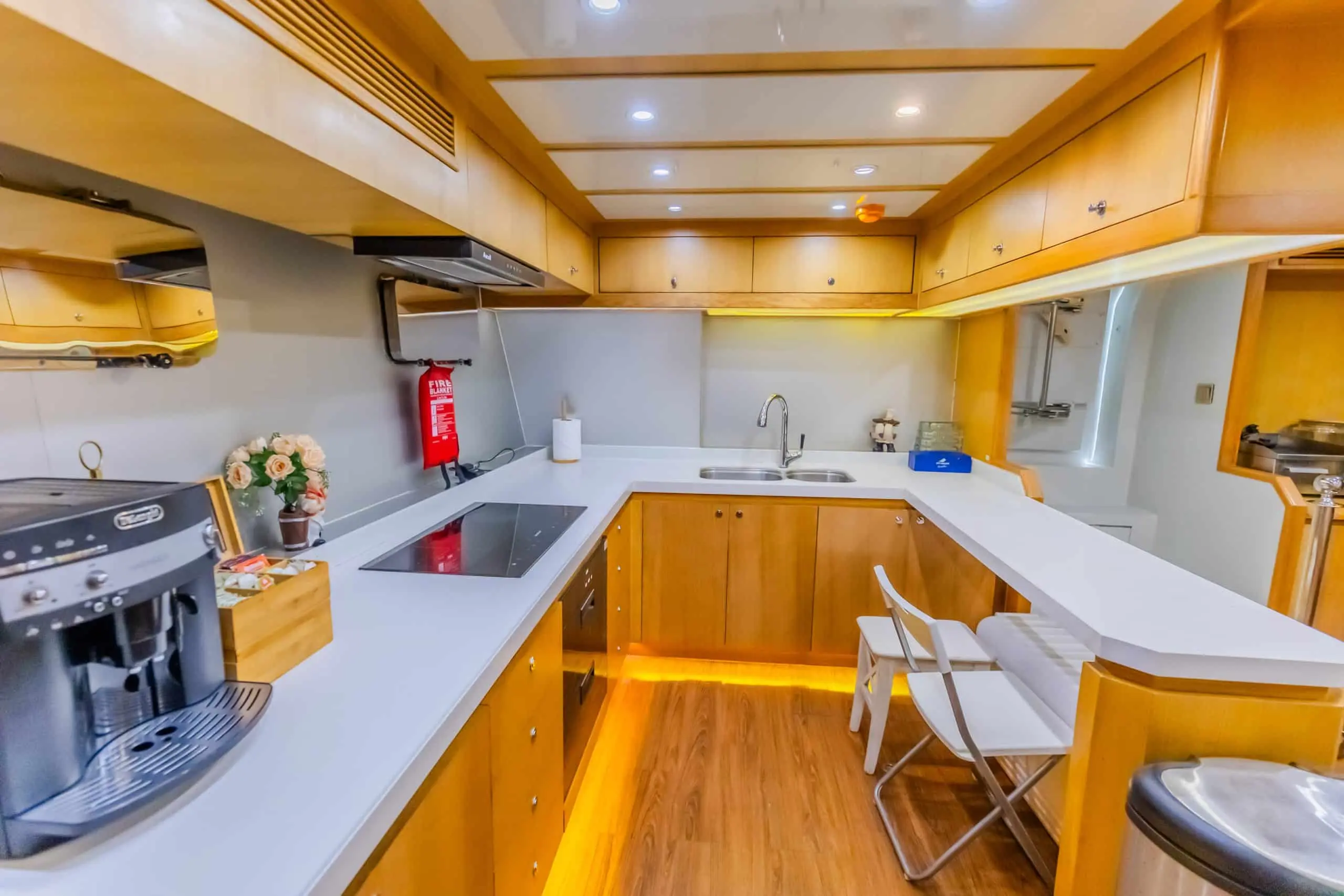 Asya 110 yacht galley kitchen with modern appliances and bar seating
