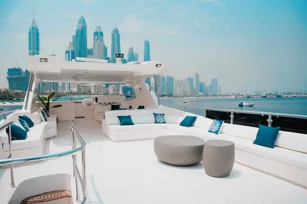 Upper deck seating area on Luna 101 yacht with Abu Dhabi skyline view at Yas Marina
