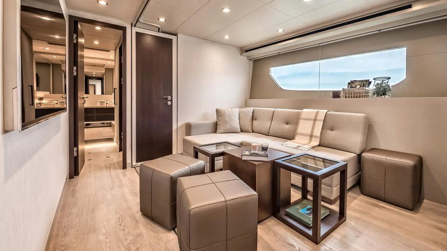 Dolce Vita yacht saloon seating area with plush sofas and natural light in Dubai marina