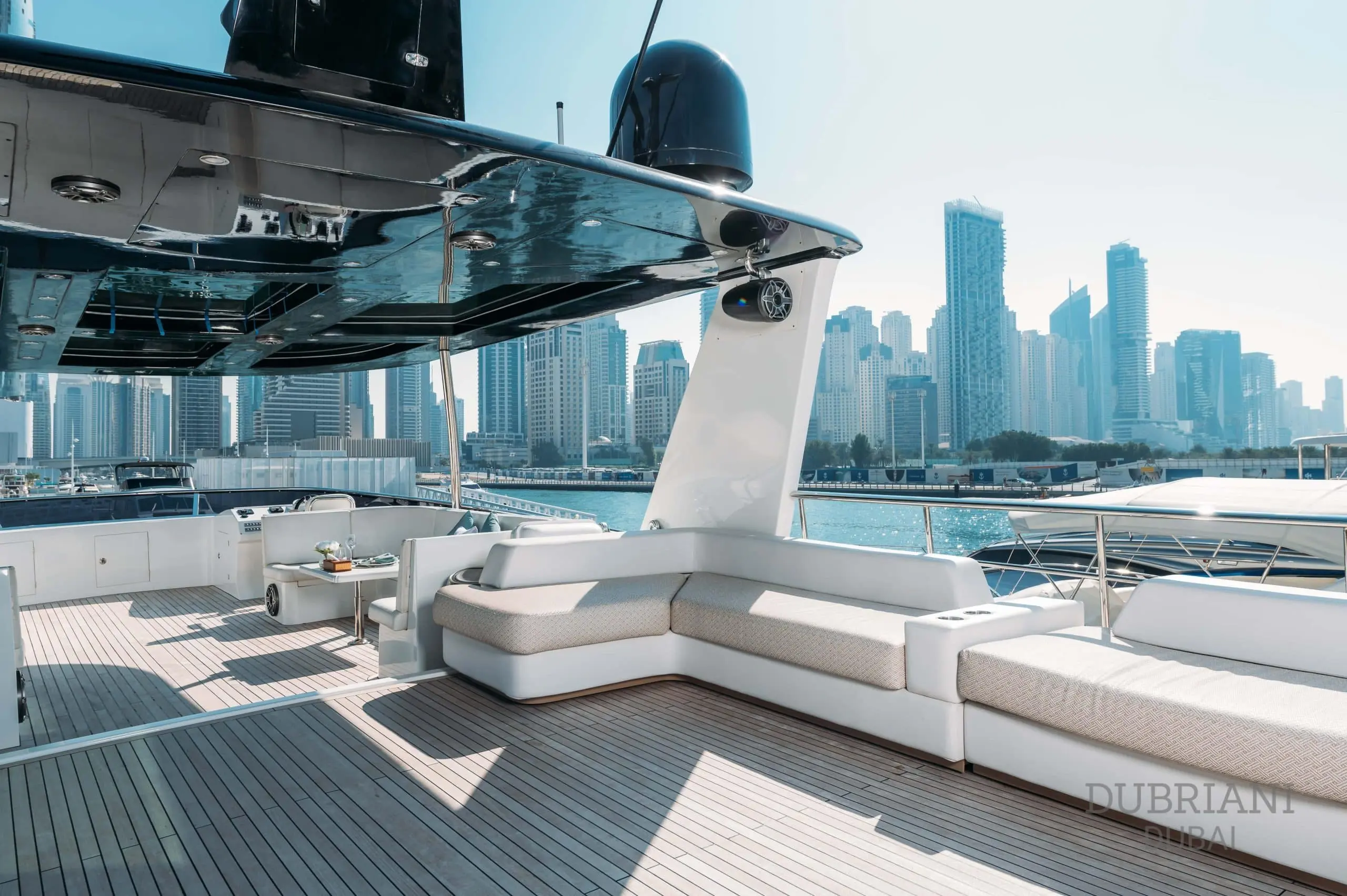 Luxury outdoor lounge and dining space on Eclipse yacht with panoramic city views