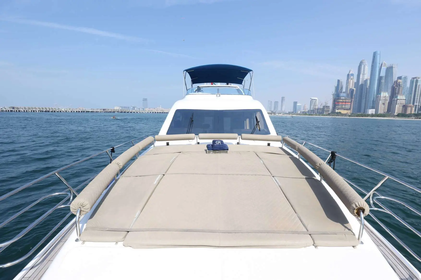 Belle 75 yacht sun deck with sea and skyline view.