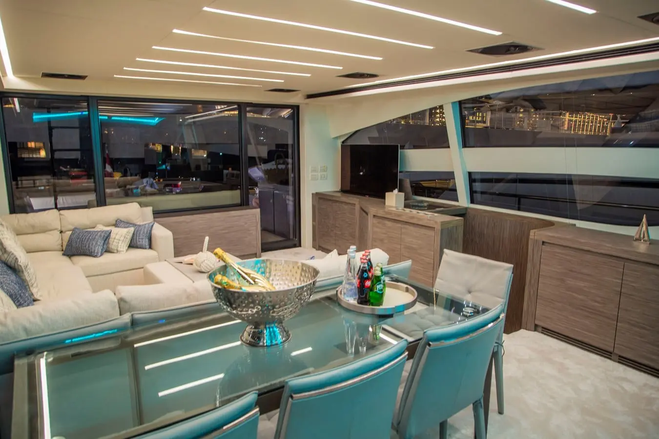 Pershing 82 saloon dining area under evening LED lighting