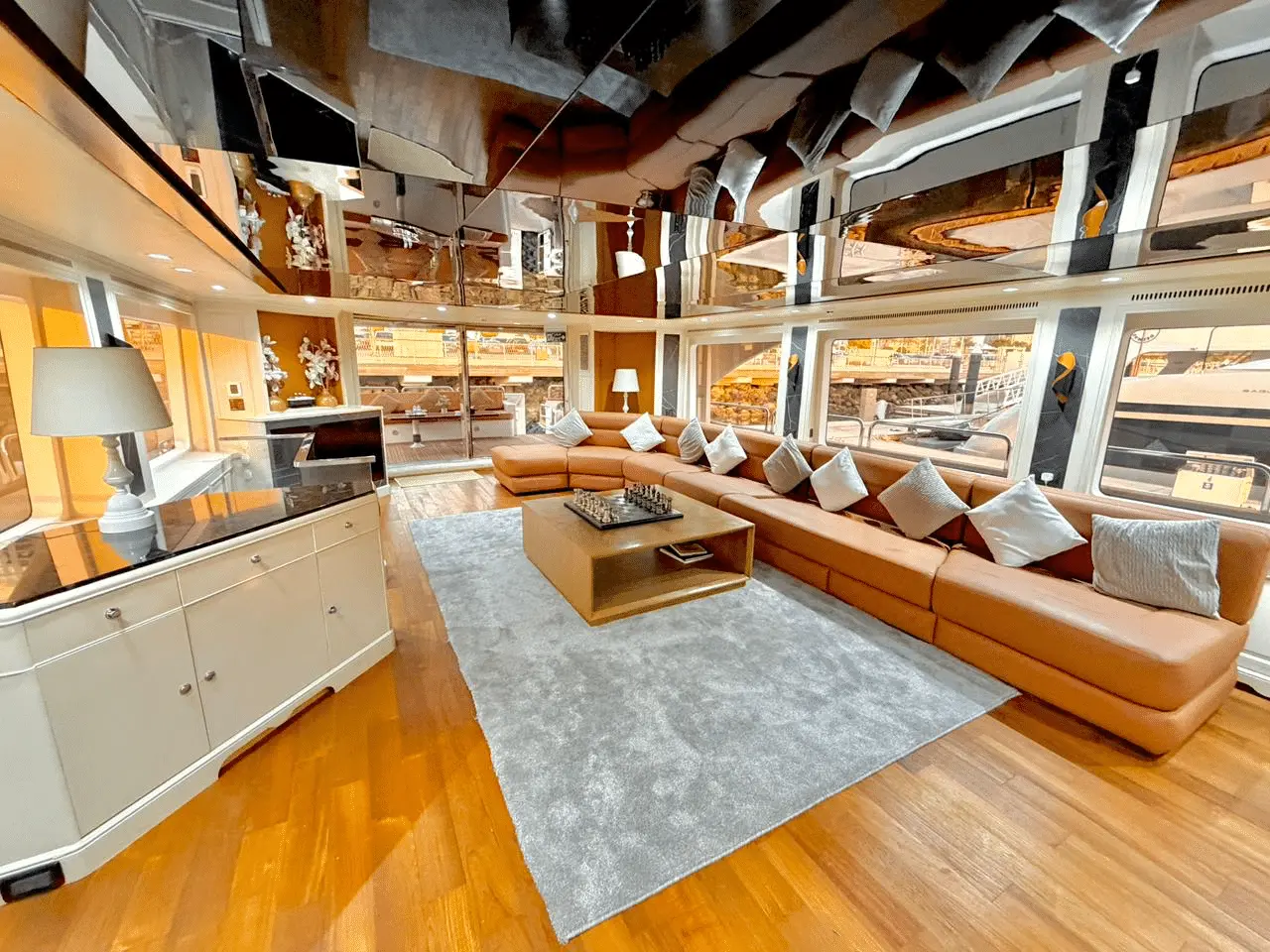 Benetti 120 main salon interior with modern sofas and large panoramic windows