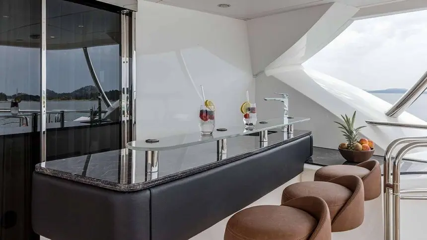Sunseeker 37M aft deck bar counter with cocktails and bar stools