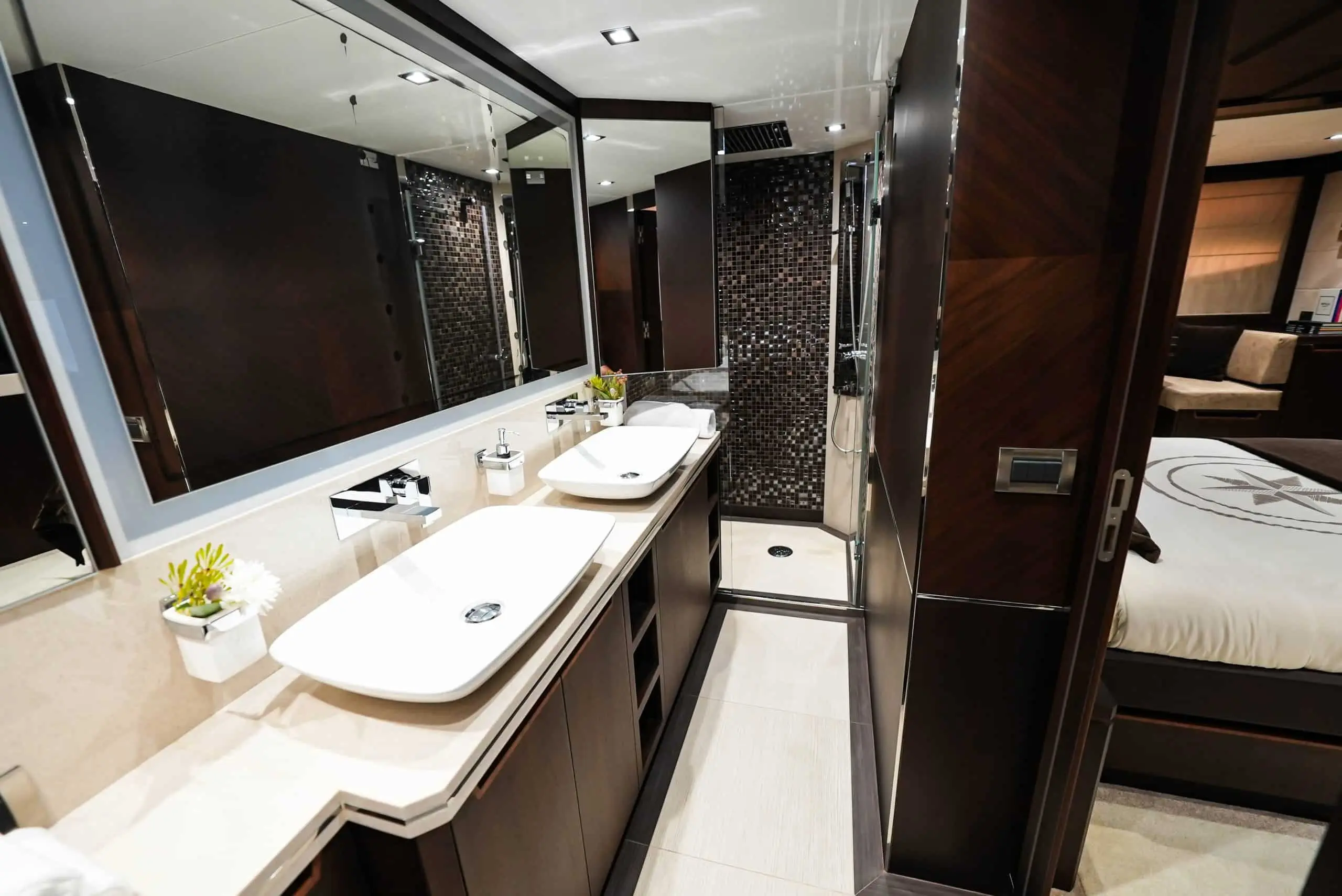 Galeon 780 F1 yacht ensuite bathroom with dual sinks, marble finishes, and glass shower