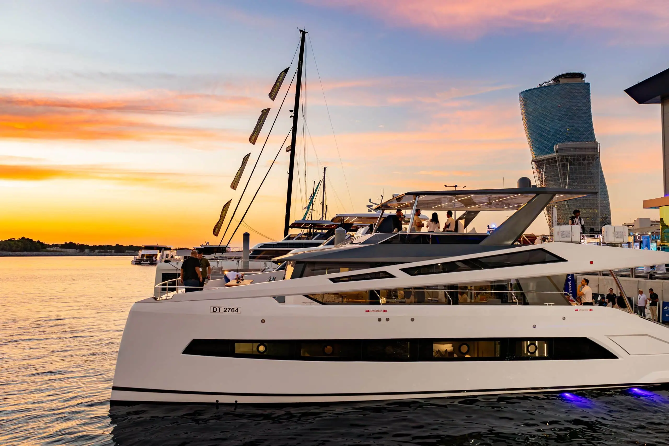 Zirve 72 yacht docked at sunset with warm sky reflections on the water