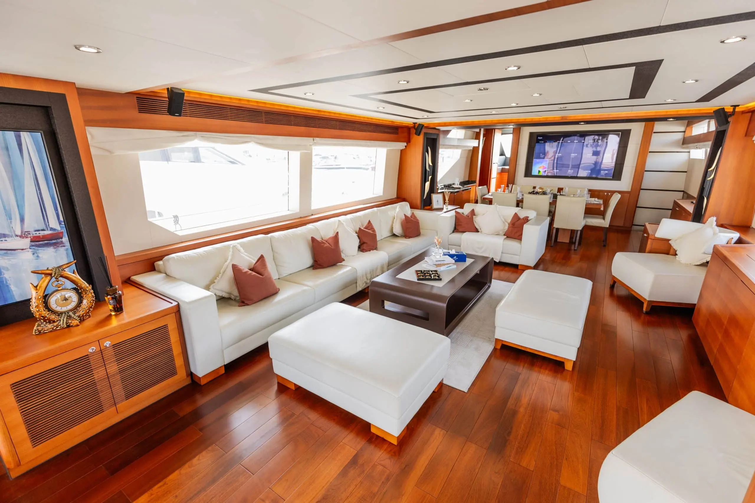 Cante 97 yacht main salon with white sofas and wooden flooring