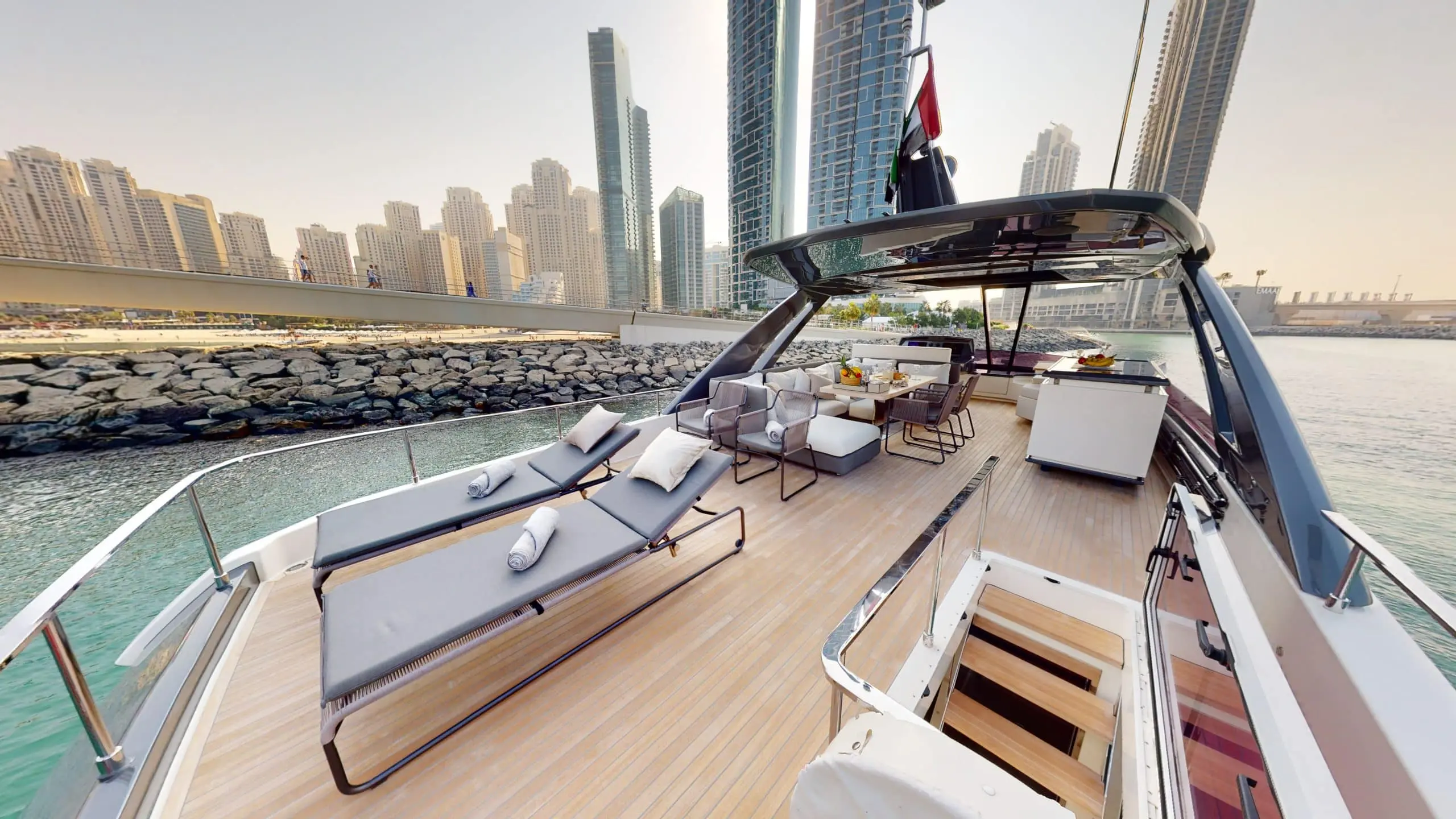 Ferretti 780 flybridge sun loungers with Dubai skyline view