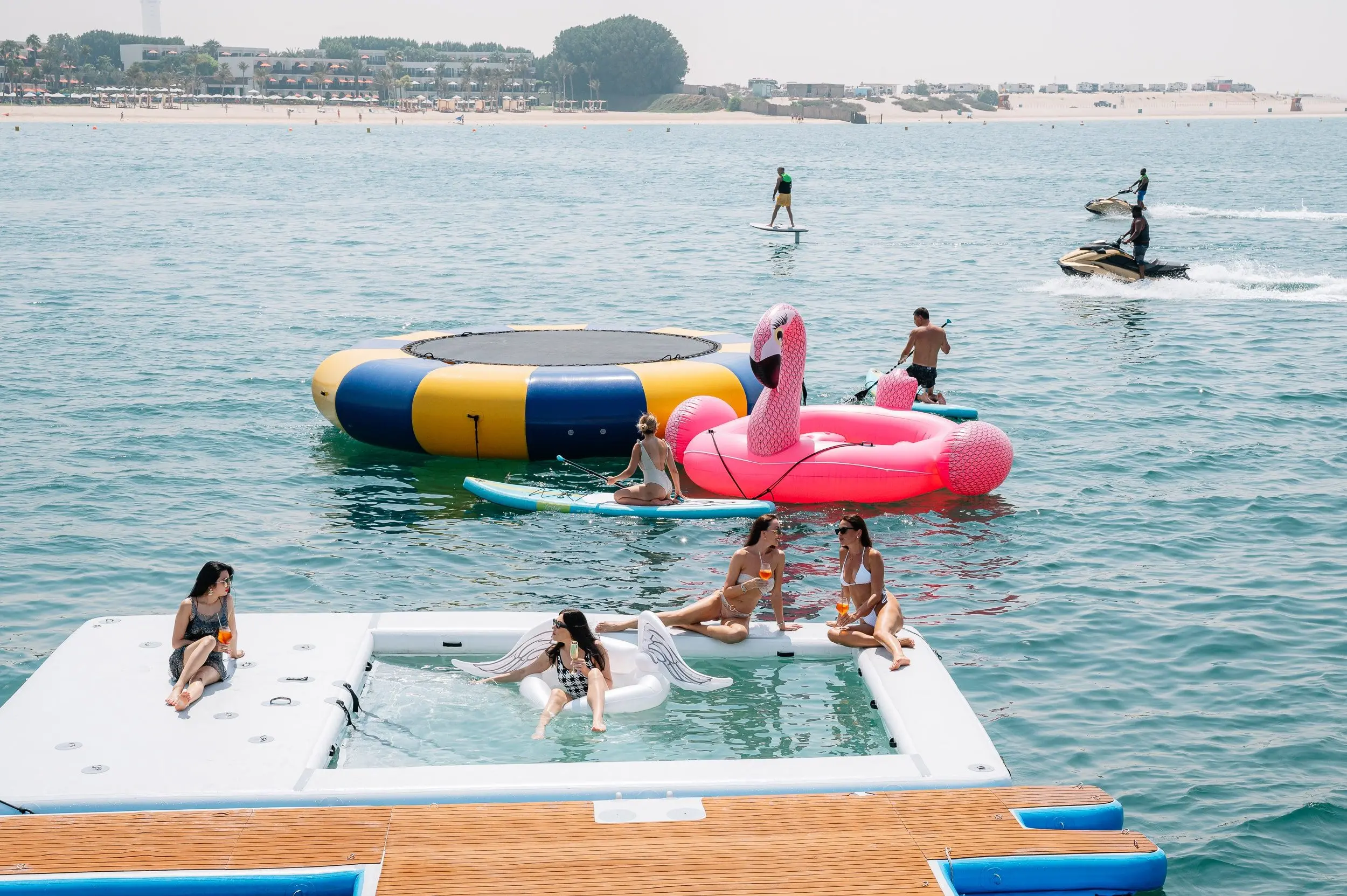 Guests enjoying water activities behind Royalty 136 luxury yacht