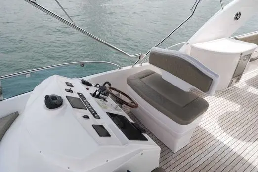 Belle 75 75ft luxury yacht flybridge helm station with teak deck and captain seating in Dubai Marina