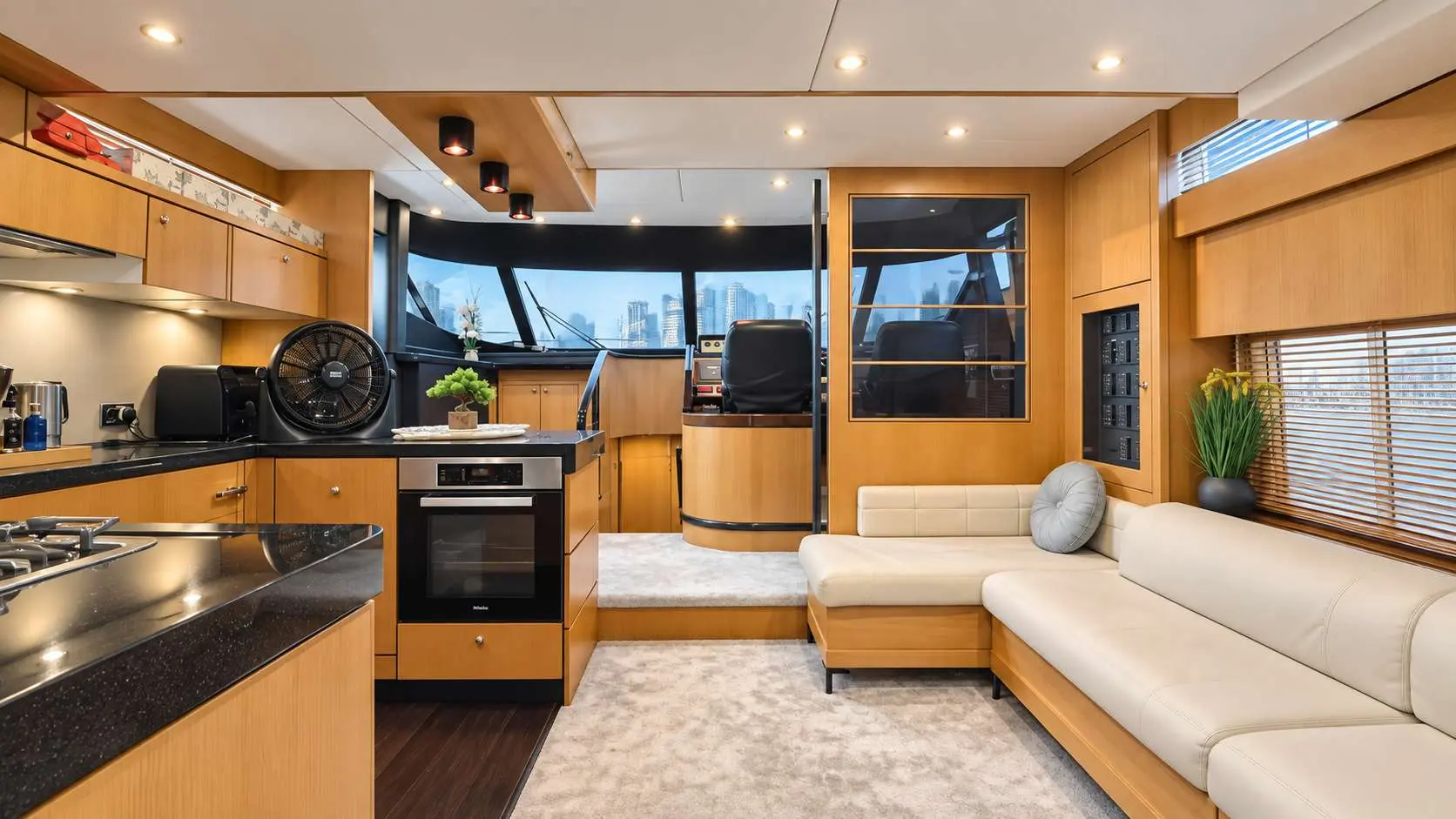 Empress 80 galley, dinette and lower helm with Dubai skyline view
