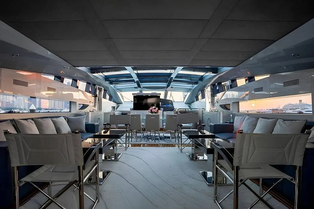 Spacious main salon aboard Baglietto 110 yacht featuring modern lounge seating and panoramic windows
