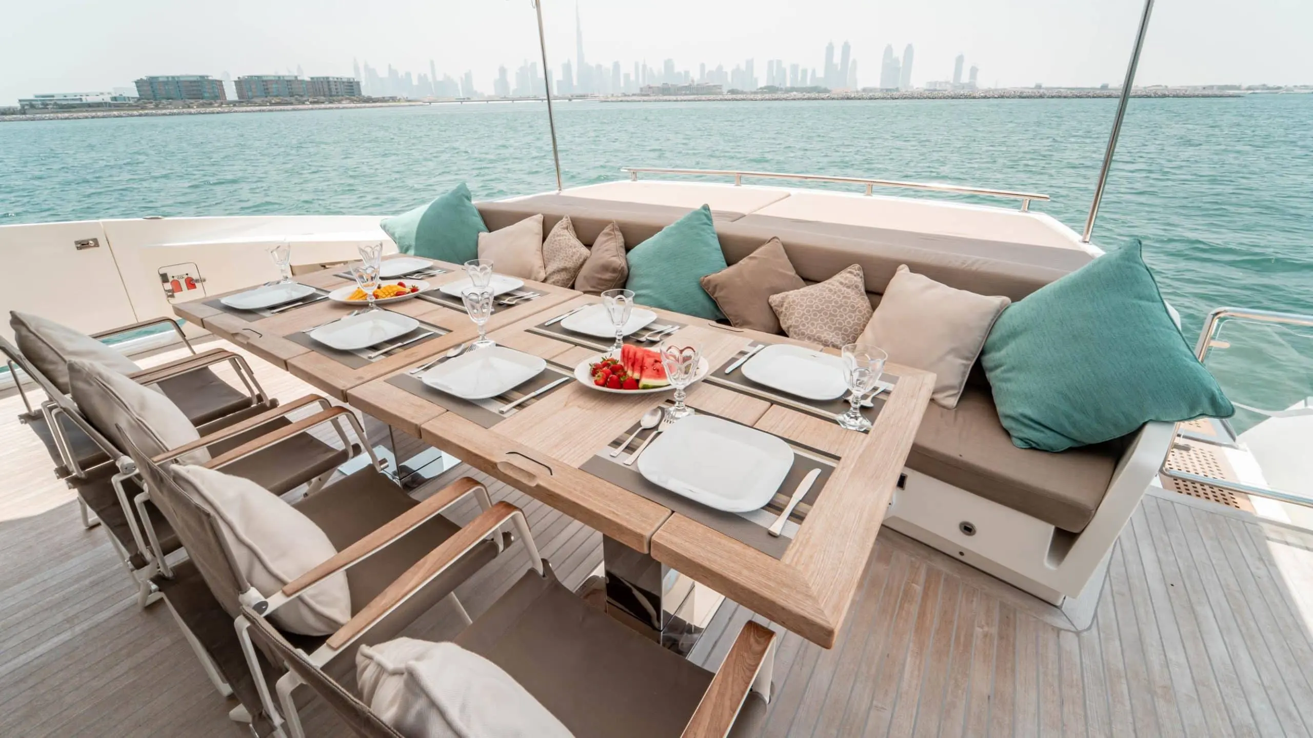 Outdoor dining table on Dolce Vita yacht with food and seating