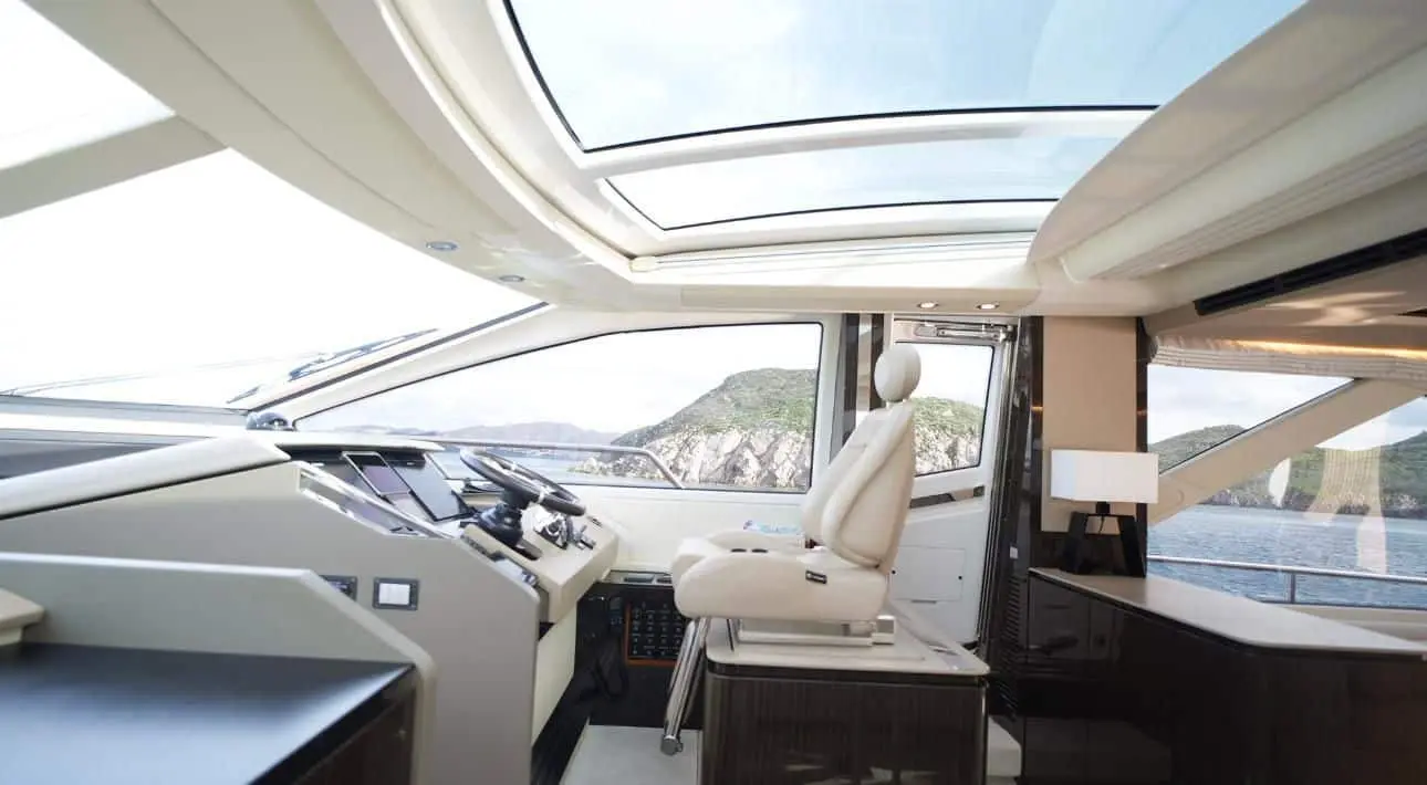 Luxury Azimut 77 yacht helm interior with panoramic windshield and captain chair