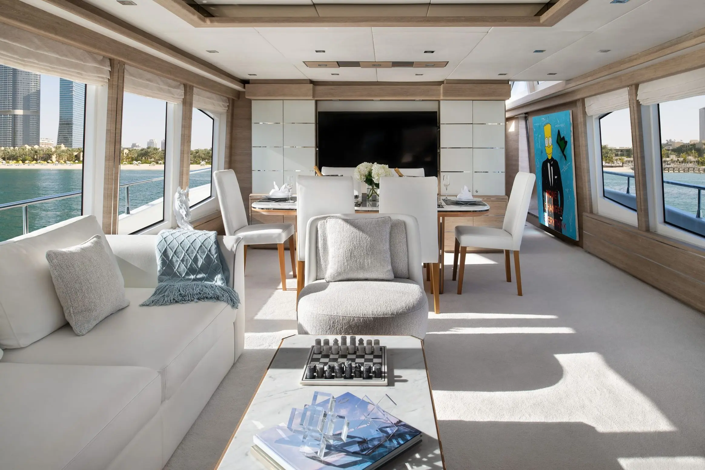 Luxury yacht interior lounge with modern sofa seating and panoramic windows in Dubai