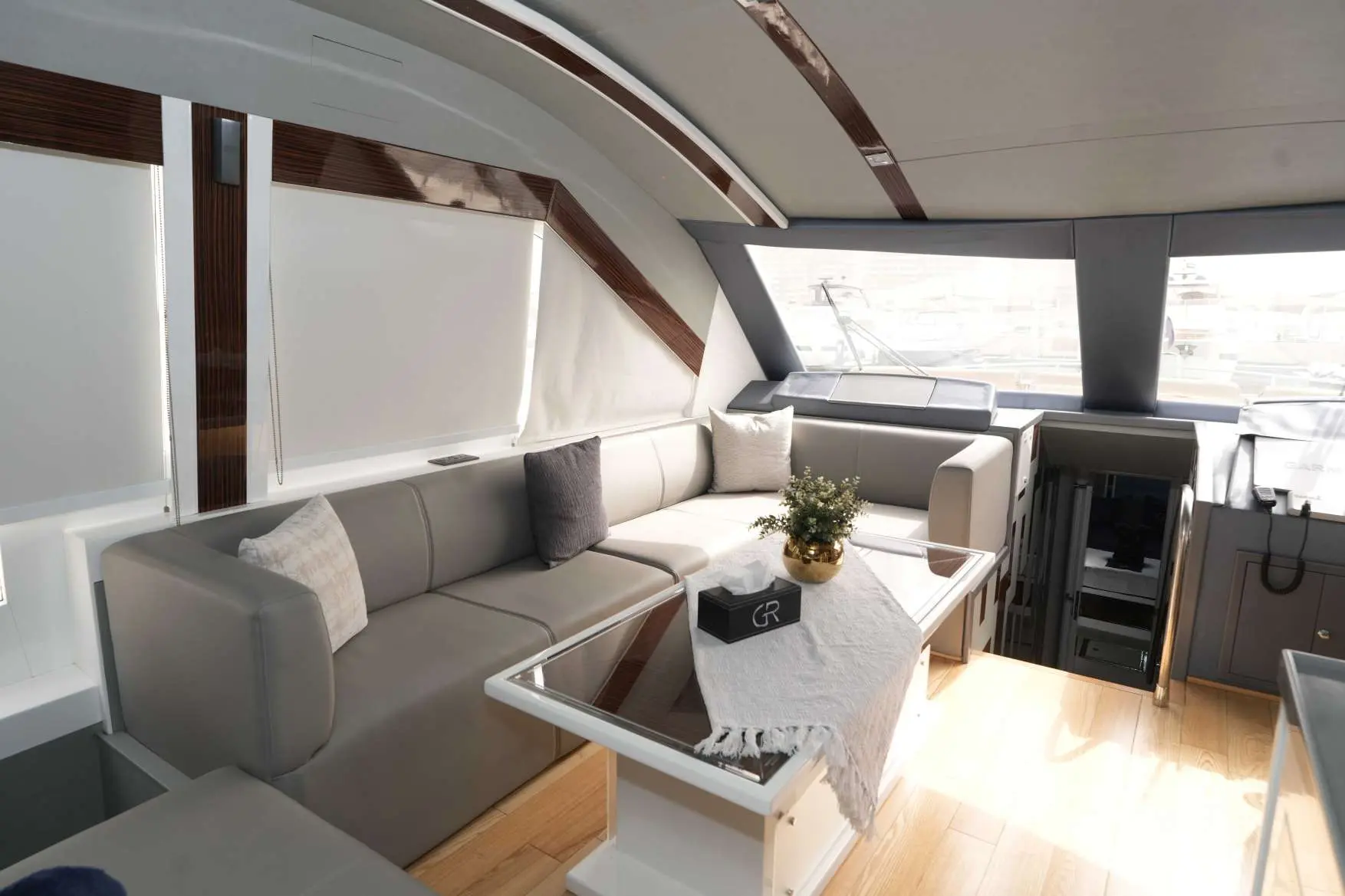 Belle 75 yacht luxury interior lounge with leather seating and panoramic windows.