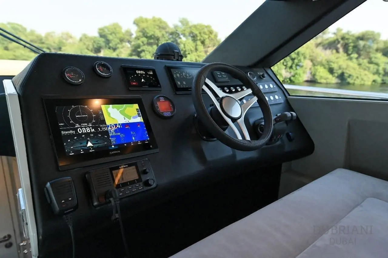 Novia 55 helm console with steering wheel, chartplotter display, engine gauges and VHF radio