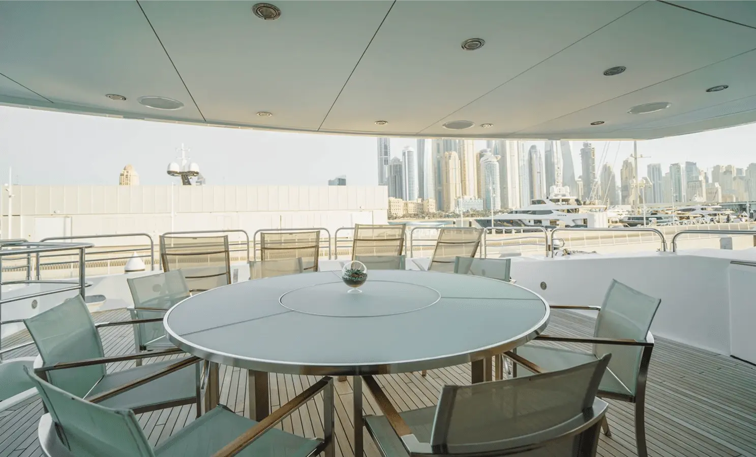 Sunseeker 40M covered aft deck with round al fresco dining table
