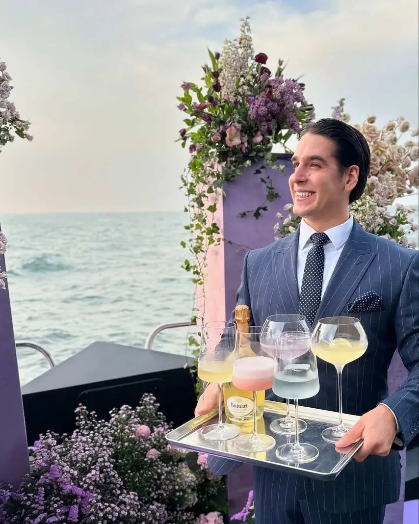 professional yacht bartender serving drinks to guest during luxury yacht experience