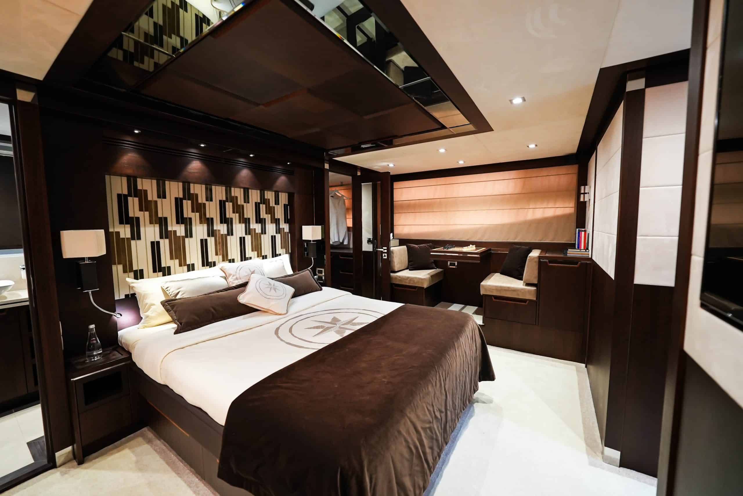 Galeon 780 F1 master stateroom with king bed, wood accents, and ambient lighting
