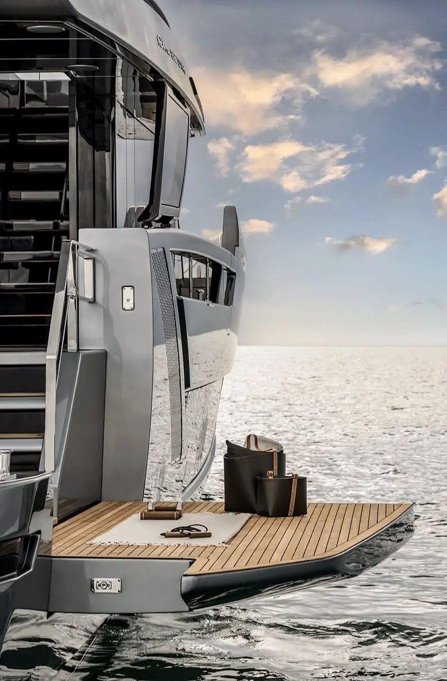 Luxury yacht swim platform with teak deck and ocean backdrop