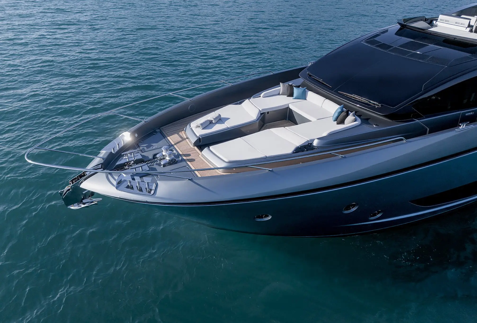 Riva 82 yacht bow sunbathing area with cushioned seating