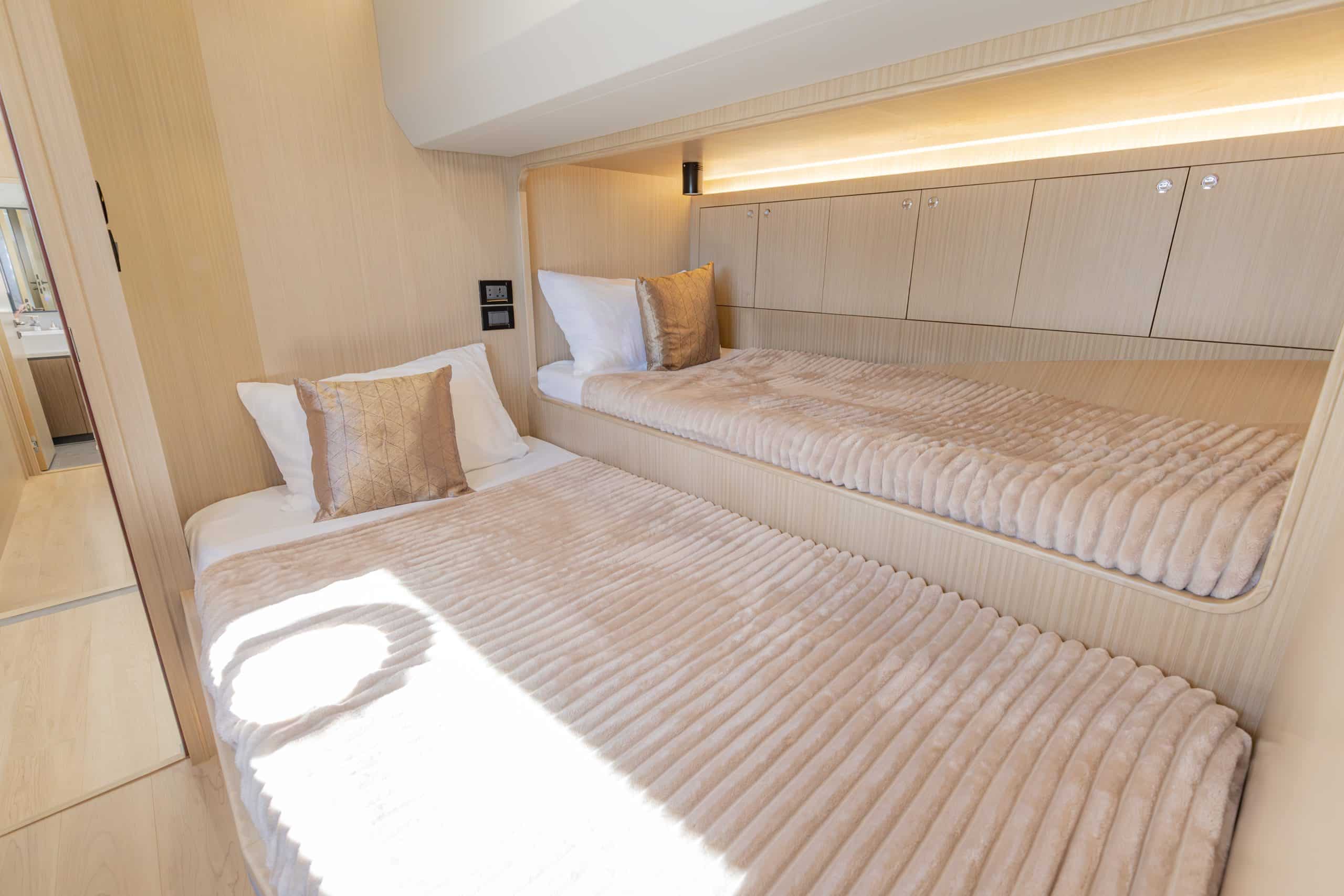 Zirve 72 yacht guest cabin with twin beds and modern ambient lighting