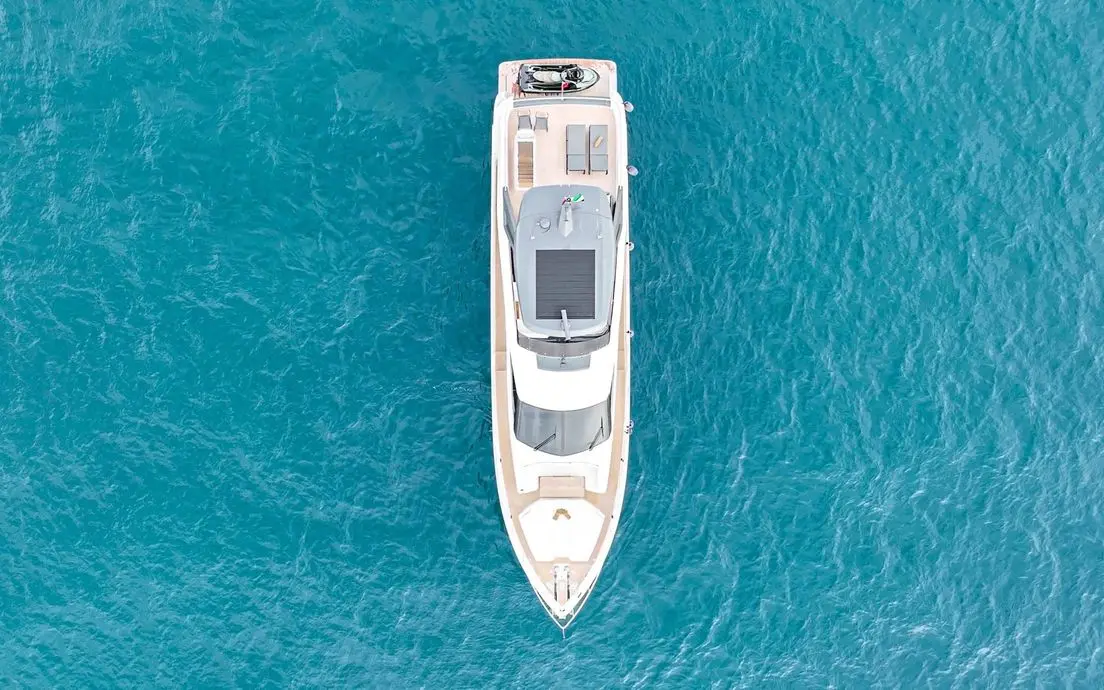 Aerial top view of Ferretti 780 superyacht in turquoise Dubai waters