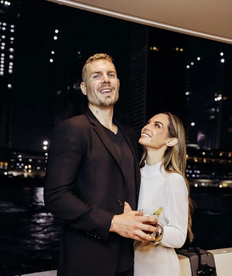 Couple embracing after yacht proposal in Dubai with skyline view