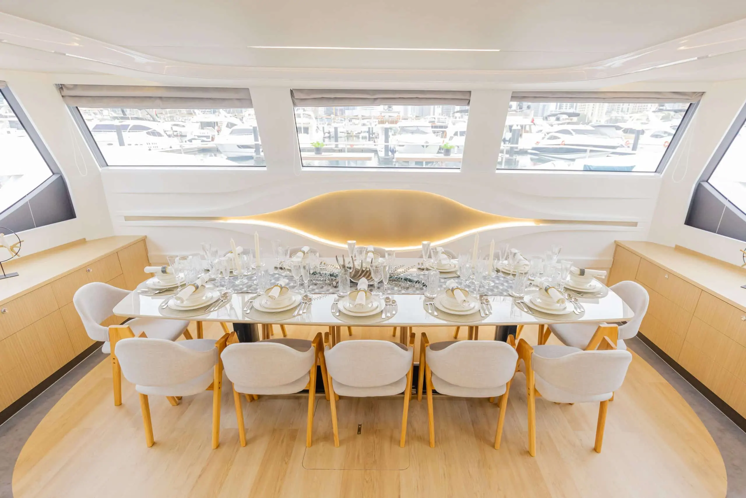 Spacious indoor dining area on the Zirve 72 yacht with panoramic windows and arranged seating