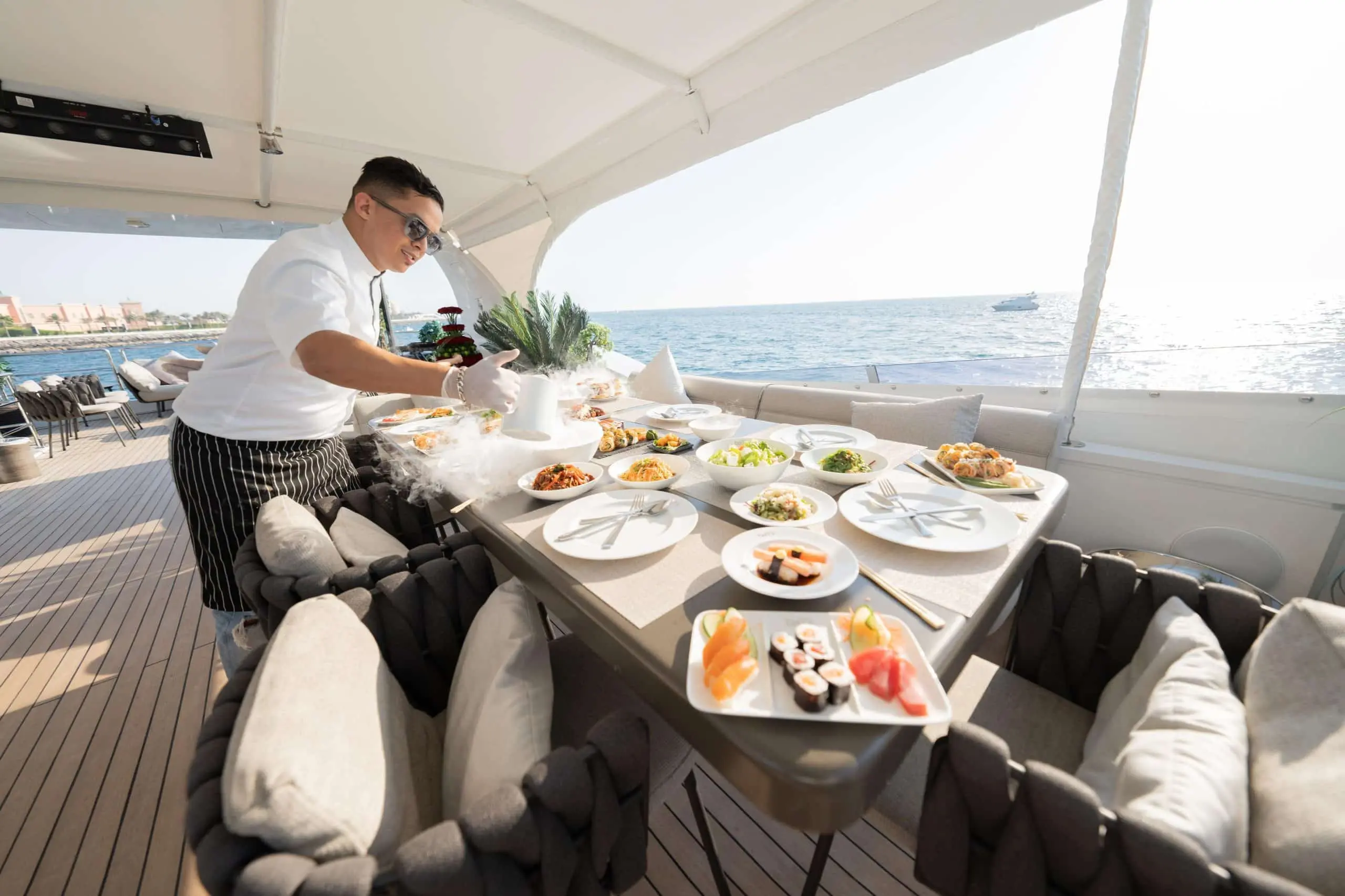 Crew member serving breakfast on Tatti 110 luxury yacht