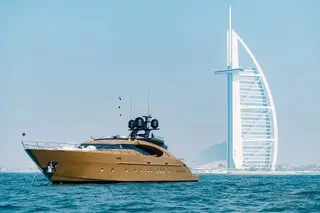 Luxury yacht cruising near Burj Al Arab in Dubai waters