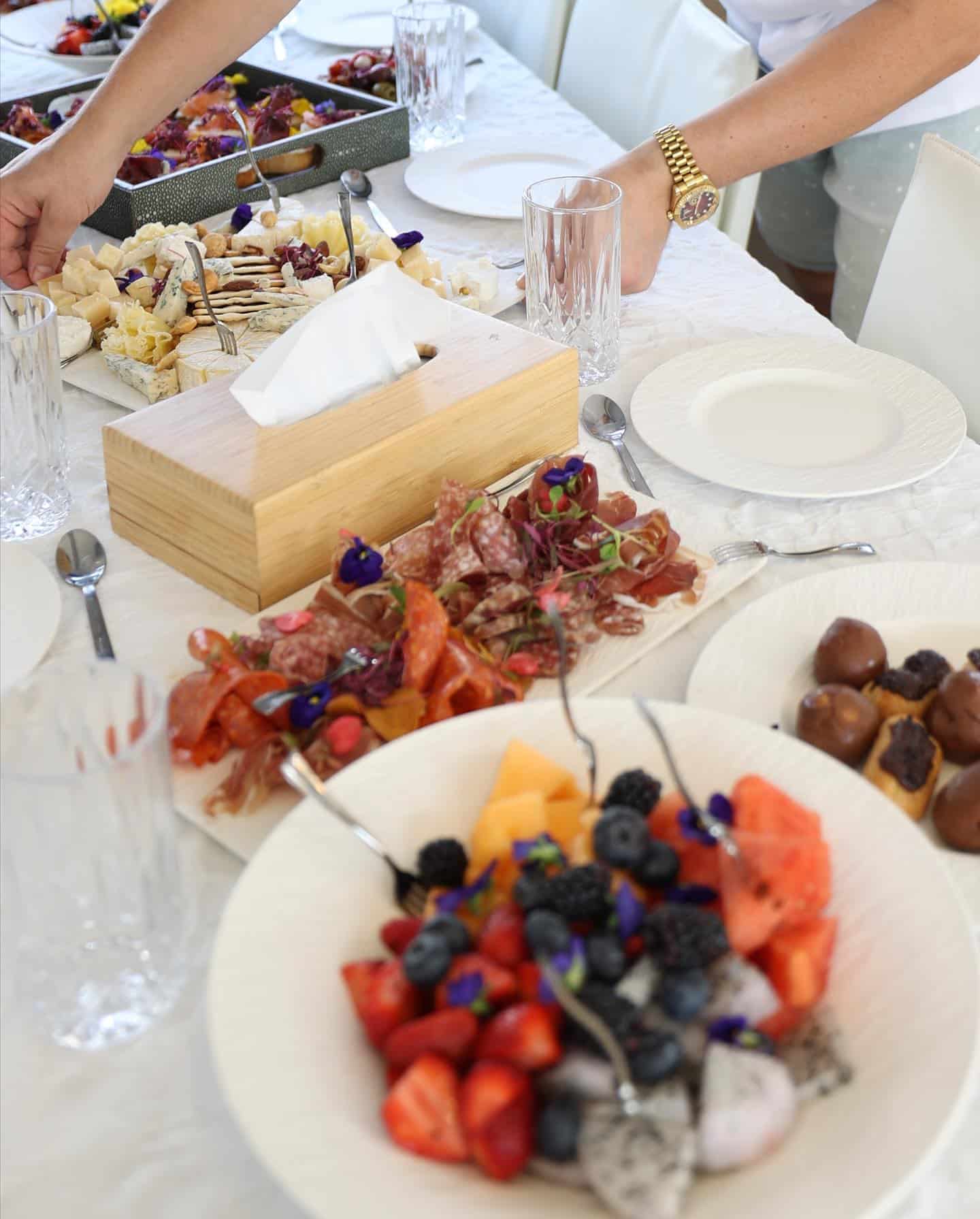 luxury yacht catering dessert table with fresh fruits and cheese display