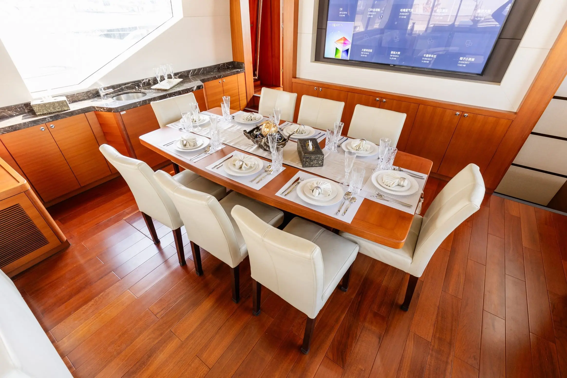 Cante 97 yacht dining area with wooden flooring and modern interior