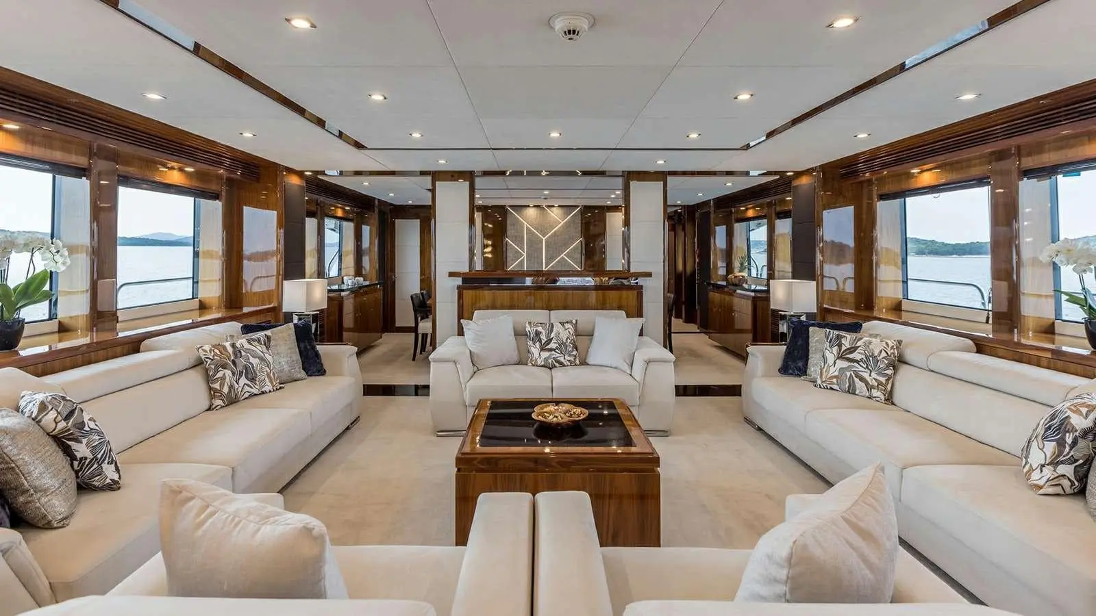 Sunseeker 37M main saloon lounge with cream sofas, wide windows