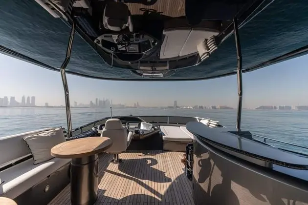 Sunseeker 82 Yacht flybridge helm and sunpad lounge under canopy