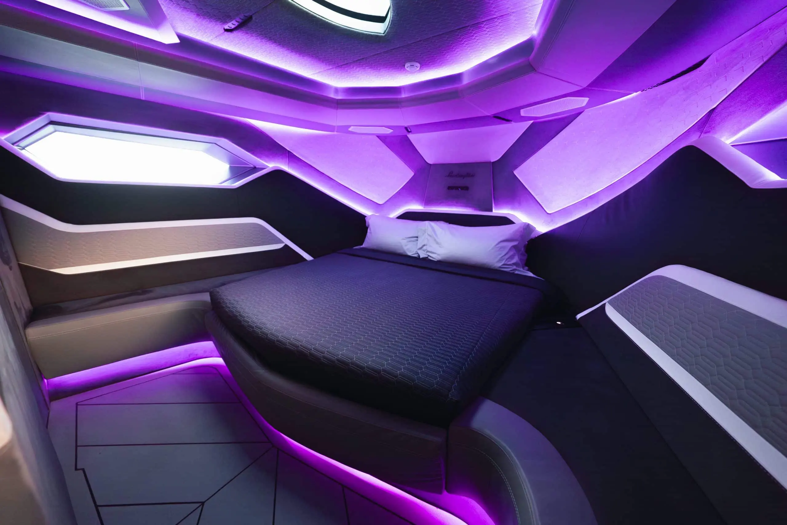 Lamborghini 63 yacht luxury seating lounge with violet ambient lighting and premium upholstery