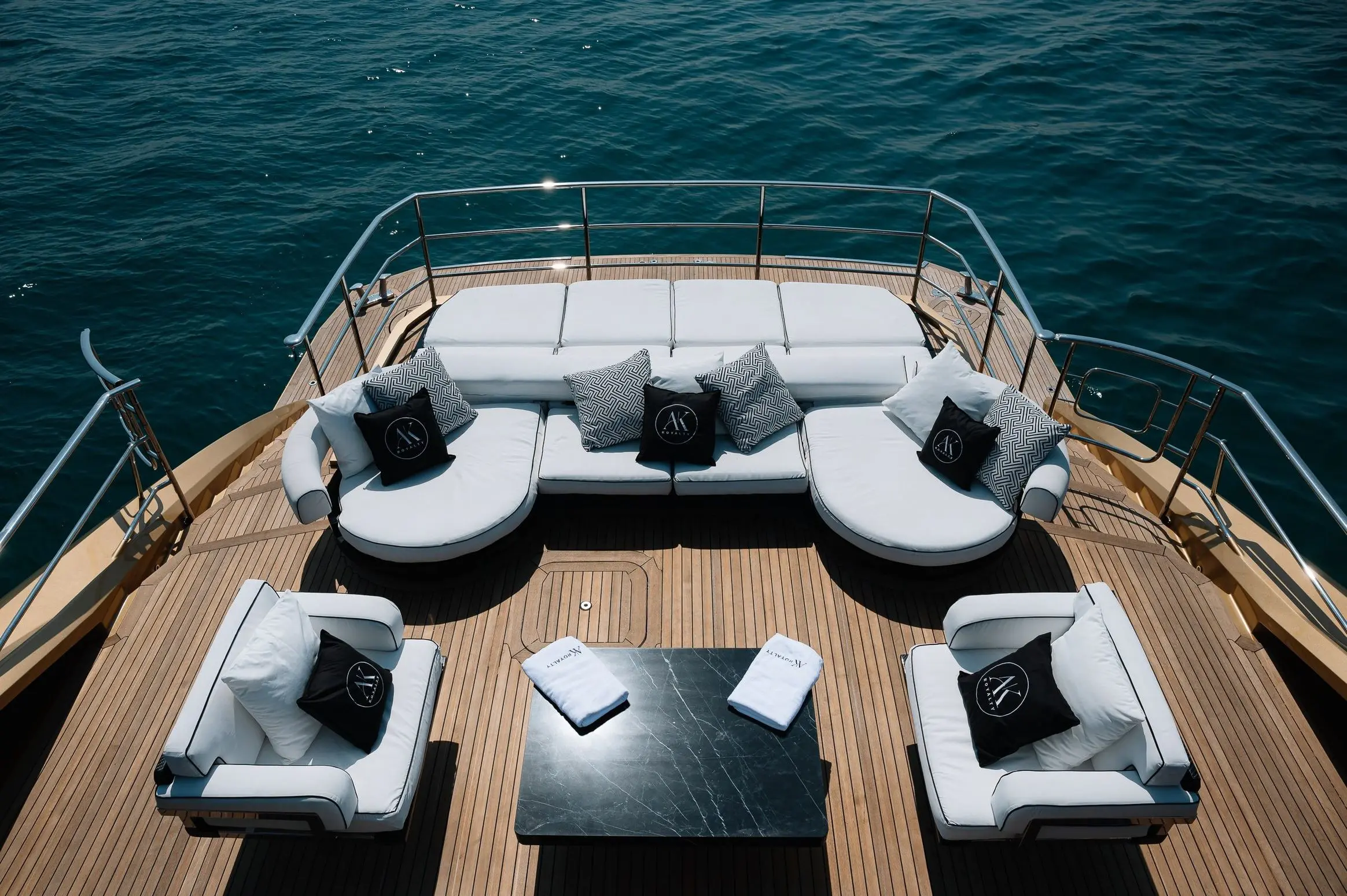 Luxury outdoor seating area on upper deck of Royalty 136 yacht