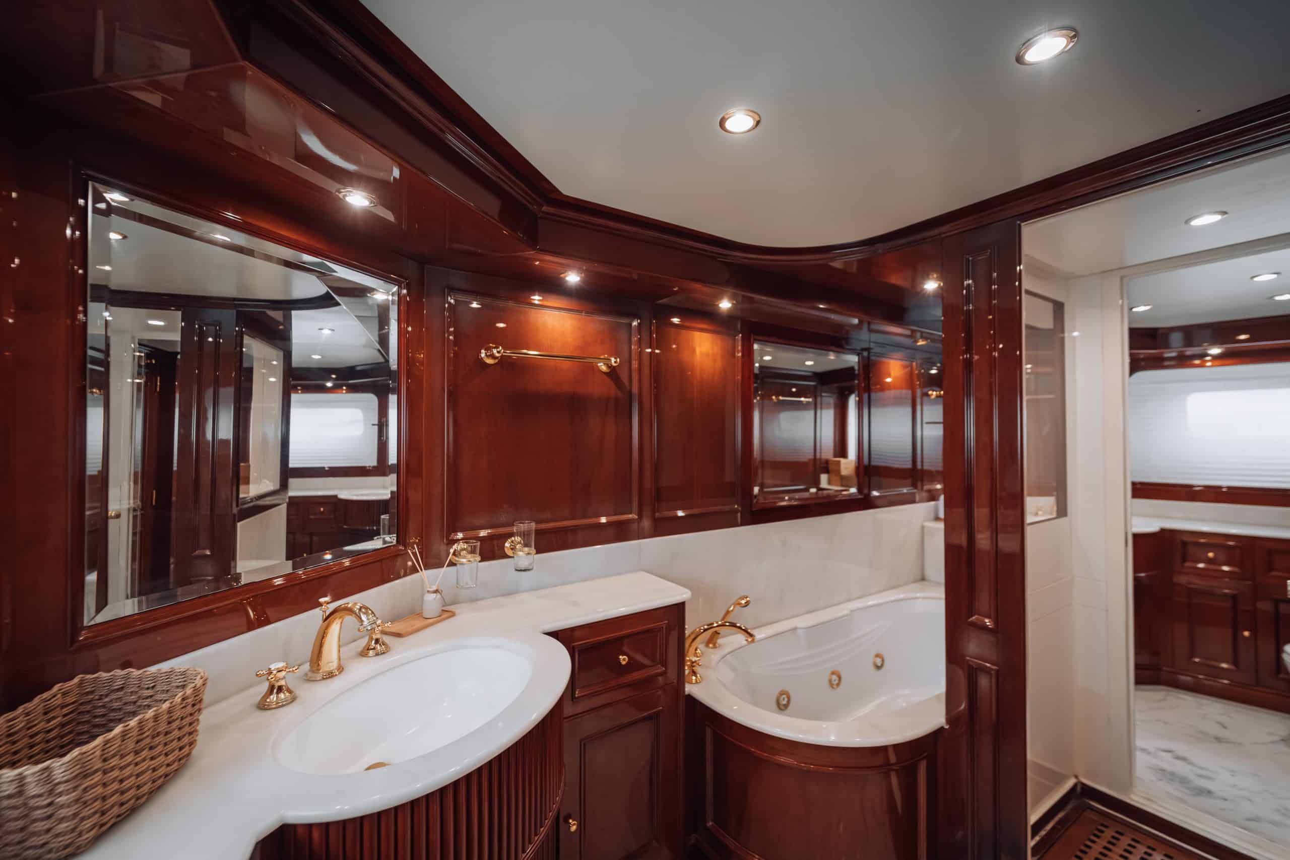 Royal Mirage yacht guest bedroom with twin beds and storage cabinets
