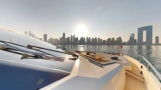 Ferretti 780 foredeck lounge area with Dubai skyline view at sunset