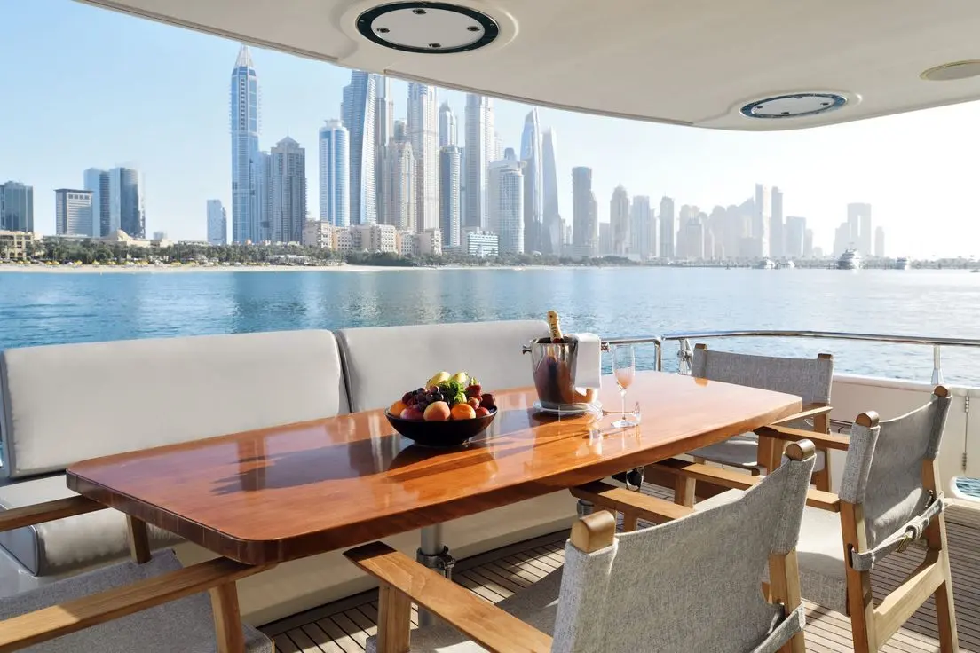 Yacht outdoor dining table with Dubai skyline backdrop